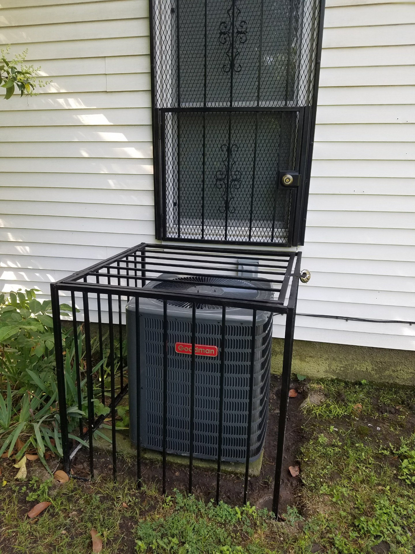 Heavy-duty steel AC security cage protecting outdoor unit